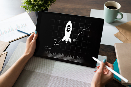 Bitcoin growth rocket icon on screen. Cryptocurrency and blockchain concept.の写真素材