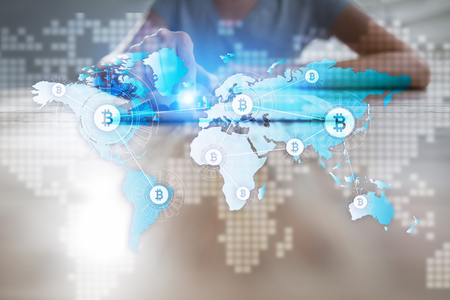 World map with bitcoin icons on virtual screen. Crypto currency. Blockchain technology. Internet payments.の写真素材