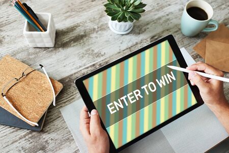Enter to win text on the screen. Giveaway. Lottery and prizes. Social media marketing and advertising concept.の写真素材