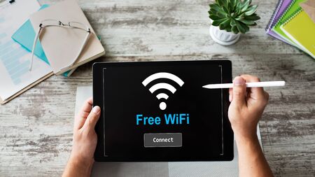 Free wifi connection on device screen. Internet and wireless technology concept.の写真素材