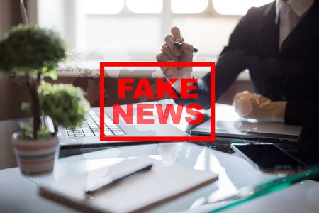 Fake news warning on the virtual screen.の写真素材