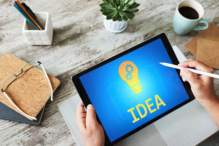 New idea, creativity and innovation concept with lamp icon on screenの写真素材