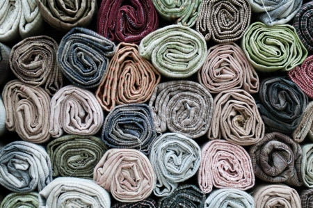 Traditional fabric store with stacks of colorful textiles  の写真素材