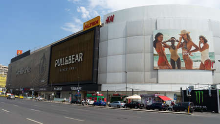 Bucharest, Romania- June the 17th, 2019: H&M, Pull & Bear, Stradivarius huge billboards mounted on a shopping mall building on Union Square (Piata Unirii). Advertisement and marketing.のeditorial素材