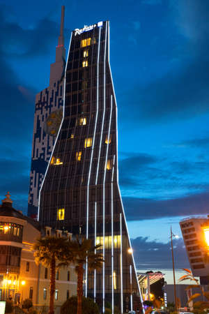 Batumi, Georgia-MAY 25, 2019: Full shot of a modern magnificent 5-star hotel by Radisson BLU, in the original night illumination. Travel and hospitality.のeditorial素材