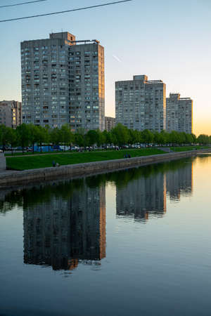 ST. PETERSBURG, RUSSIA- MAY 18-2019: A row of residential Houses on (Chicken) Legs, Soviet constructivism situated alongside the Smolenka river on the Vasilievskiy island. Sunset rays touching the building. The design is based on architect Le idea of Unitのeditorial素材
