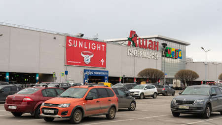 St. Petersburg, Russia- MARCH 26, 2021: The parking lot near Auchan (in Russian or cyrillic) in MEGA Dybenko, a large supermarket store.のeditorial素材