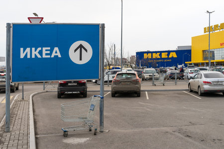 St. Petersburg, Russia- MARCH 26, 2021: Directional sign with arrow of the IKEA store in Russian or Cyrillic opposite the IKEA warehouse and store, the largest retailer of the home goods.のeditorial素材