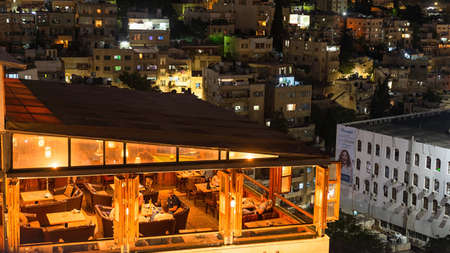Top night shot of lit-up roof Talet Al Jabal restaurant in the central neighborhood in Amman, Jordanのeditorial素材