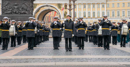 A military brass band is performing during the rehearsal of the military parade for the 76th Victory Day on Palace Square, St. Petersburg, Russia, with General Staff building in the backgroundのeditorial素材