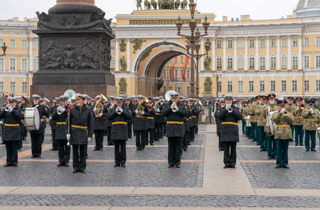 A military brass band is performing during the rehearsal of the military parade for the 76th Victory Day on Palace Square, St. Petersburg, Russia, with General Staff building in the backgroundのeditorial素材
