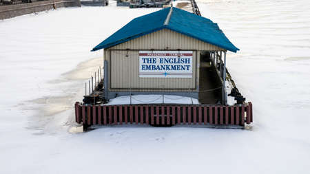 ST PETERSBURG, RUSSIA-MARCH 31, 2021: The passenger terminal for cruise ships and other vessels on the frozen with ice Neva river. Travel and transportation.のeditorial素材