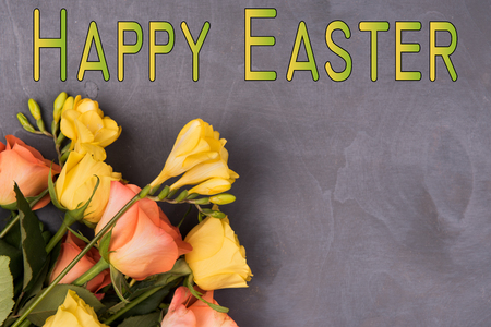 happy easter with fresh flowers, on a natural wooden backgroundの写真素材