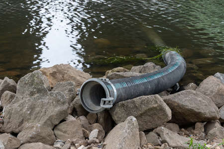 A pipeline protrudes from the River Danube in Regensburg to the shore