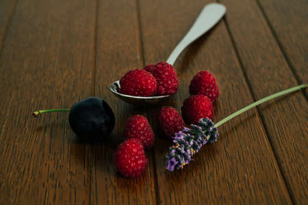 Dark food photography, raspberries with cherry. Template for menu cards, expense cards, magazines.の写真素材