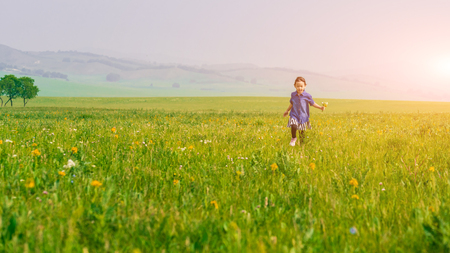 A girl playing on the prairieの写真素材