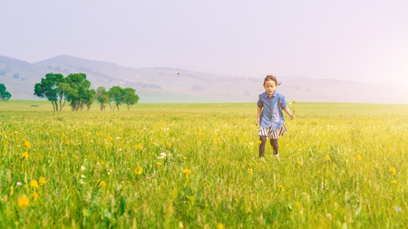 A girl playing on the prairieの写真素材