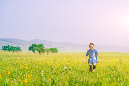 A girl playing on the prairieの写真素材