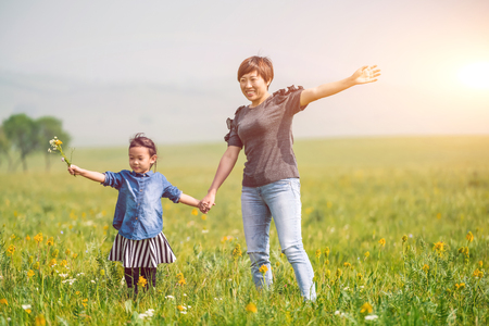Mother and daughter in the summer prairieの写真素材