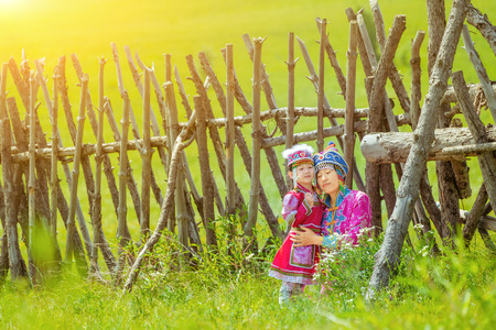 Mother and daughter wearing Mongolian costumes on the grasslandの写真素材