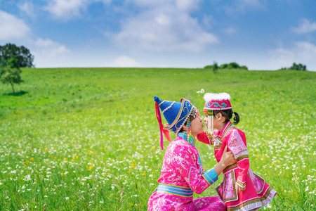 Mother and daughter wearing Mongolian costumes on the grasslandの写真素材
