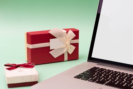 Laptop and gift boxes on green backgroundの写真素材