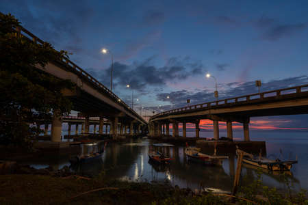 Blue hour burning sunrise over the bridge.の写真素材