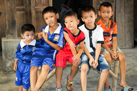 This is a picture of children five people sitting on a bamboo stretcher happy to be photographed. Everyone smiled with delight . When I saw this picture, I want to be kids again.のeditorial素材
