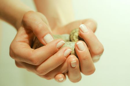 Stones hold in feminine handsの写真素材
