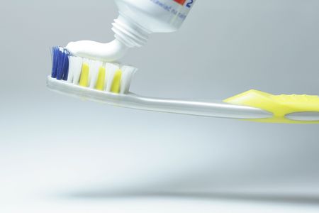 Squeezing toothpaste onto tooth-brushの写真素材