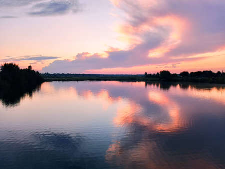 Orange sky sparkles in the mirror waterの写真素材