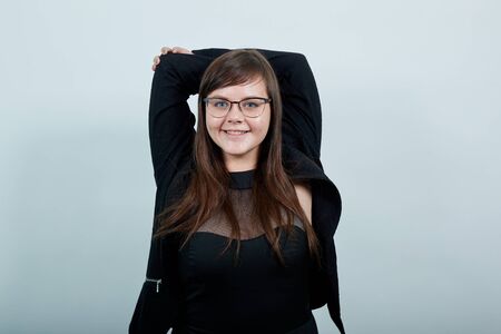 Surprised cheerful young woman in casual shirt, looking camera, spreading hands over head isolated...