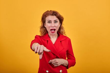 Caucasian young woman pointing finger at camera, looking shocked, attractive lady wearing fashion...