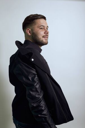 Young Bearded Dark Haired Man In Black Stylish Shirt, Jacket On Gray Background, Serious Male Sheds...