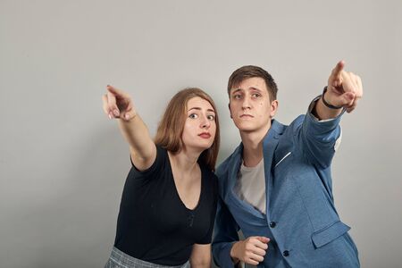 Hand pointer with forefinger pointing forward. Index finger to show direction. Means choosing, introducing too. Indicating towards. Young attractive couple boyfriend girlfriend two peopleの写真素材