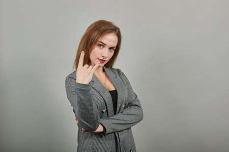 Giving rock and roll sign, showing symbol of the horns, language gestures with fingers. Young...