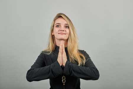 Folded hands together praying asking God for help ask implore wish upwards Jesus Christ. Young...