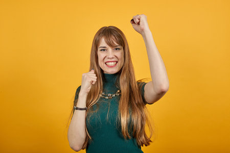 Excited young celebrating win, showing yes gesture, rejoicing success, reading good news, online lottery victory. Overjoyed crazy casual victorious event expressing emotions face isolated backgroundの写真素材