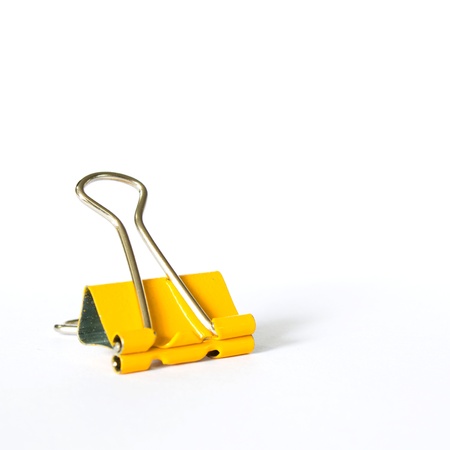 Photo of Yellow metal paperclips on white backgroundの写真素材