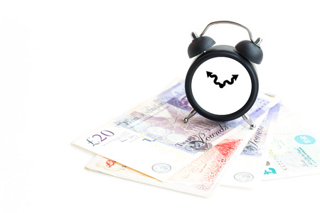 Clock, money and book isolated on white