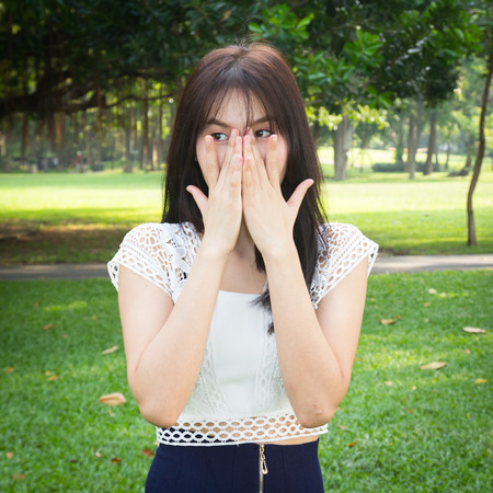 Photo of Young woman hands hand over mouth and noseの写真素材