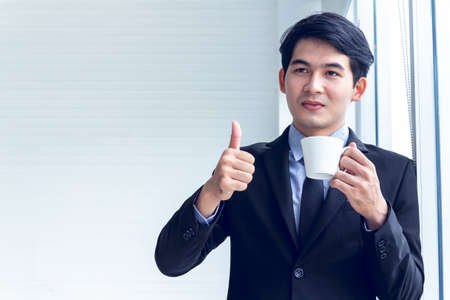 Portrait of young asian business  take action drinking a coffee cup to find idea for business...