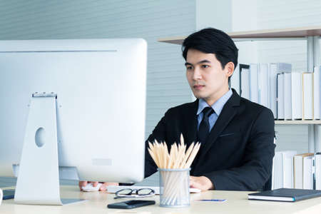 Portrait of young asian business  take action looking computer monitor to find idea for business finance concept.の写真素材
