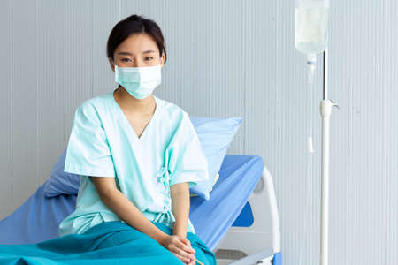 Asian women have stress. Due to coronavirus or covid 19 infection and recovering In a patient bed in a special patient room.の写真素材
