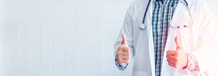 The doctor standing and put his hand thumb up in the medical room for concept Ideal about diagnosis with modern medicine.の写真素材