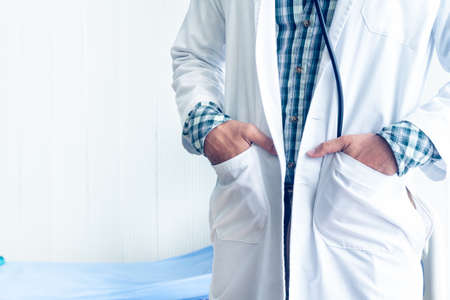 The doctor standing and put his hand in his pocket in the medical room for concept Ideal about diagnosis with modern medicine.の写真素材