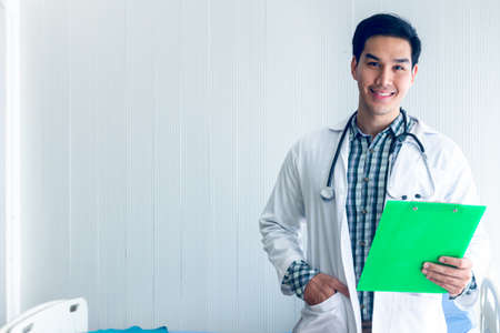 Portrait of a smart doctor standing in the medical room wait for diagnosing patient and treatment in new concept modern medicine.の写真素材