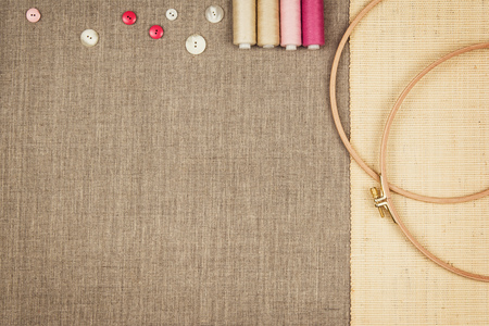 Group of sewing objects lying flat on a natural linen background. Horizontal background for ad or packaging.の写真素材