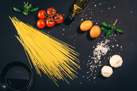 Food concept background. Black desk or chalkboard seen from above, top view. Copy space around...