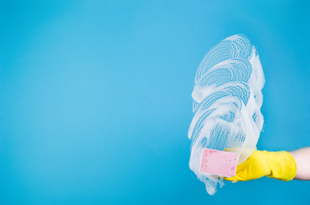 Cleaning conept - hand cleaning glass window pane with detergent and wipe or rag